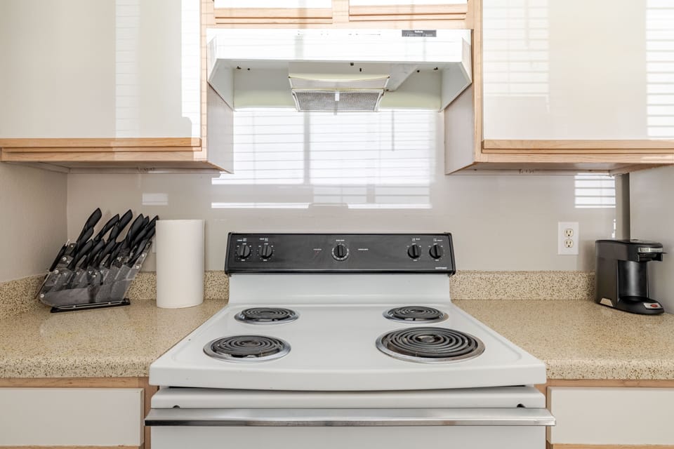 Bright, guest-ready kitchen with stove, coffee maker, and ample counter space