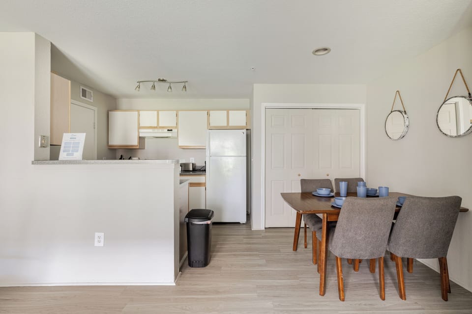 Bright open dining area with full kitchen and seating for four