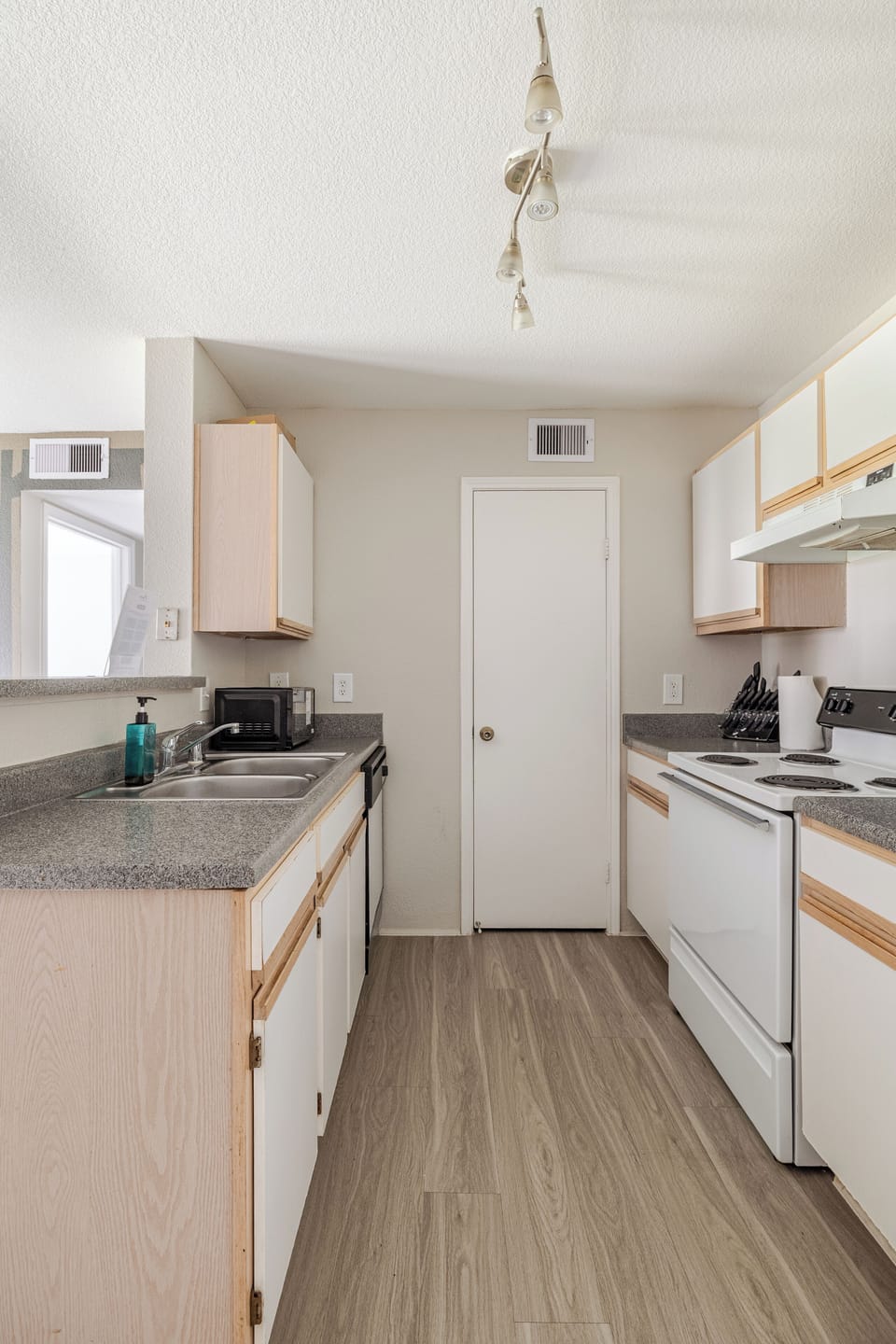 Bright galley kitchen with full-size appliances and ample counter space