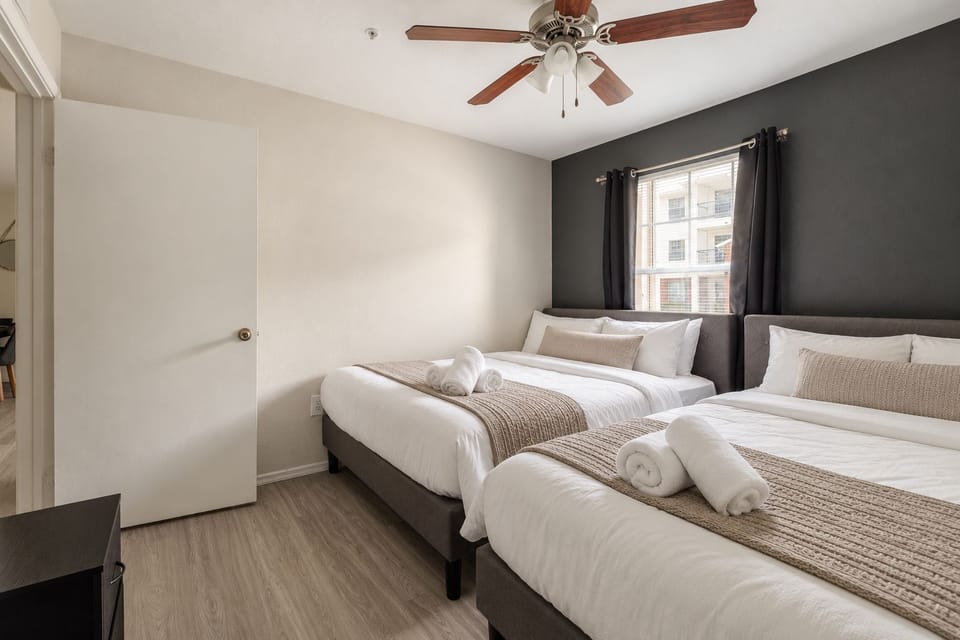 Bright double-queen bedroom with modern style and natural light