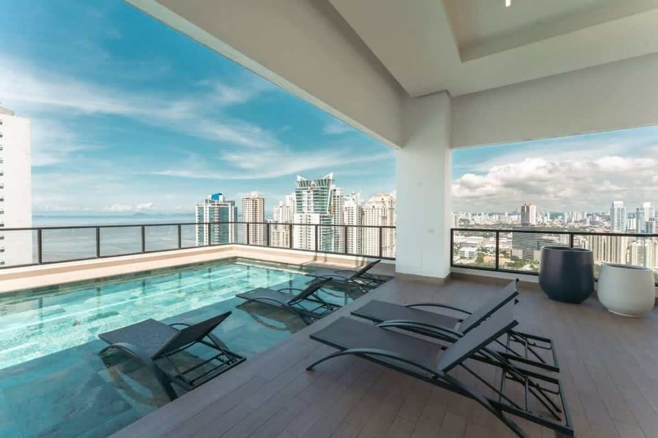 Building rooftop pool with loungers