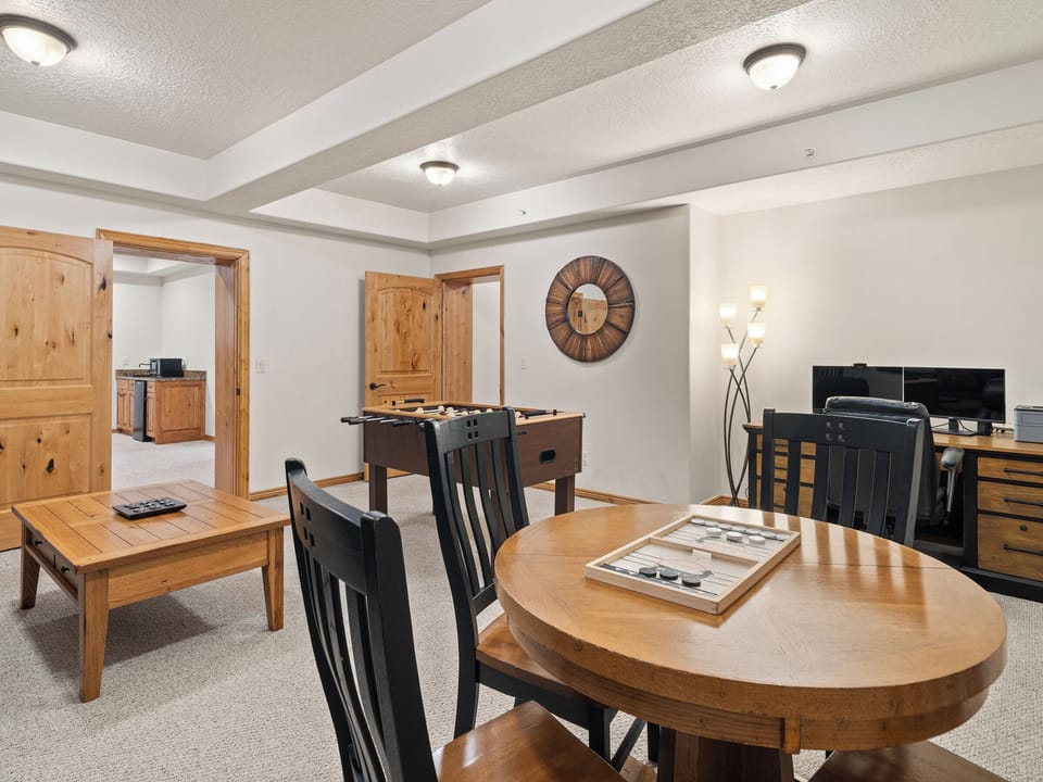 A versatile lower-level living space with dining and lounge areas, ideal for casual entertaining or extended guest stays.