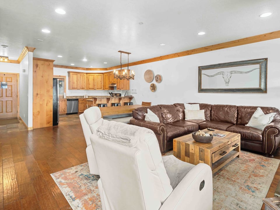 Spacious open-concept living area with comfortable seating and mountain-inspired décor.