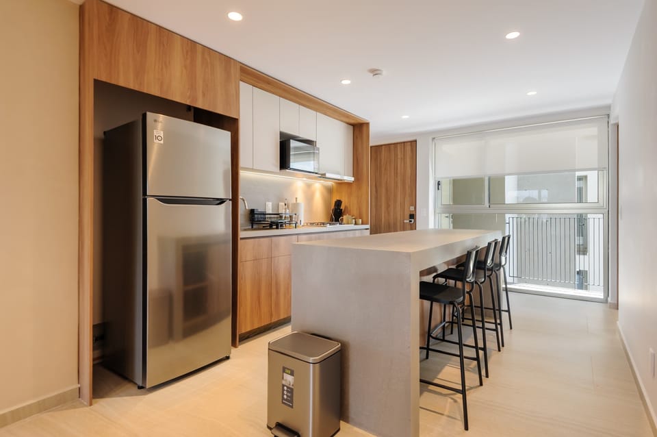 Modern kitchen with island and full appliances
