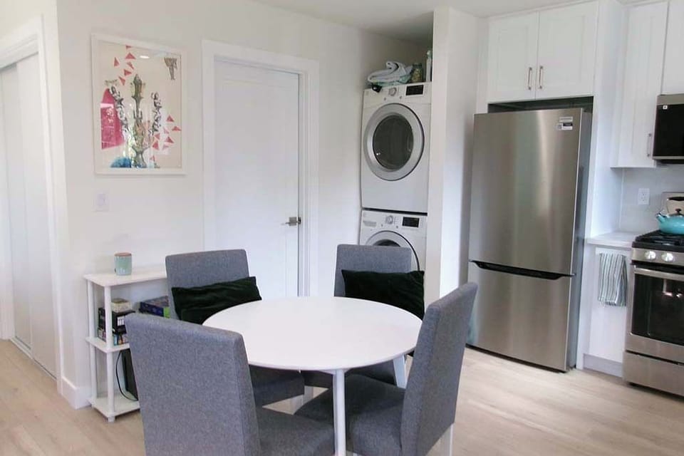 View of dining area, full kitchen, morning light
