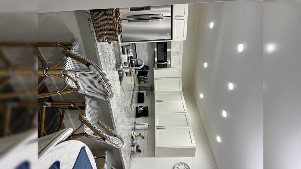 microwave, kitchen visible, indoor, kitchen, stovetop, kitchen island with seating
