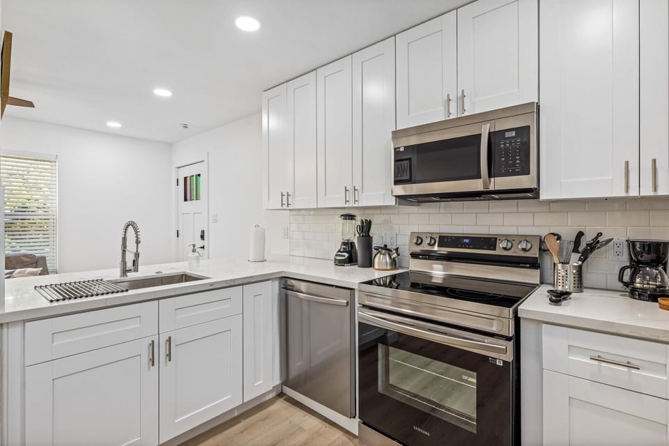 A thoughtfully designed  kitchen featuring all appliances, including a convenient dishwasher.