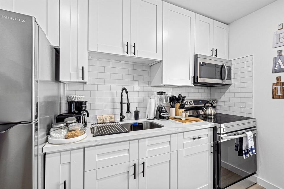 Fully stocked kitchen with all essentials, including coffee, sugar, cream, and tea, to make cooking at home easy.
