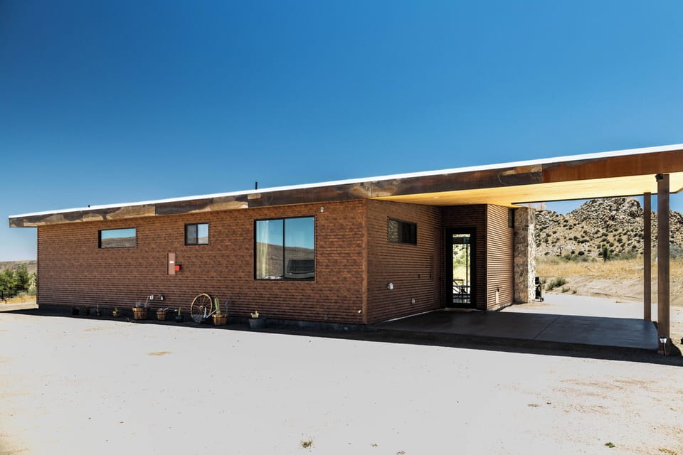 Modern desert retreat with covered parking and scenic mountain views