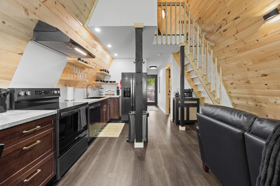 Open kitchen and living area with staircase