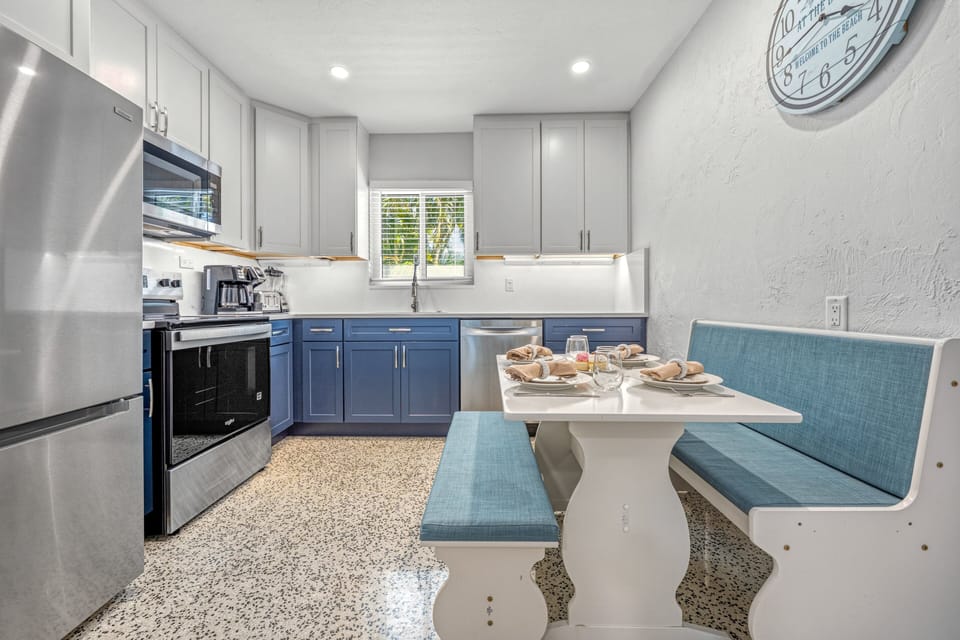 Cook and dine with ease in this clean, well-equipped kitchen setup.
