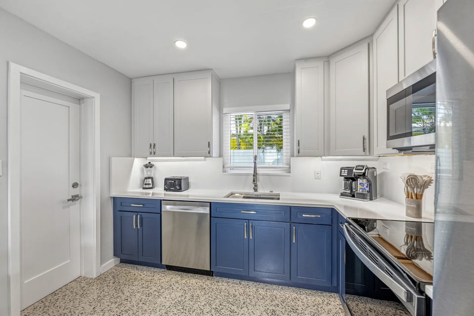 Modern kitchen with stainless steel appliances and a coffee maker ready for slow mornings.