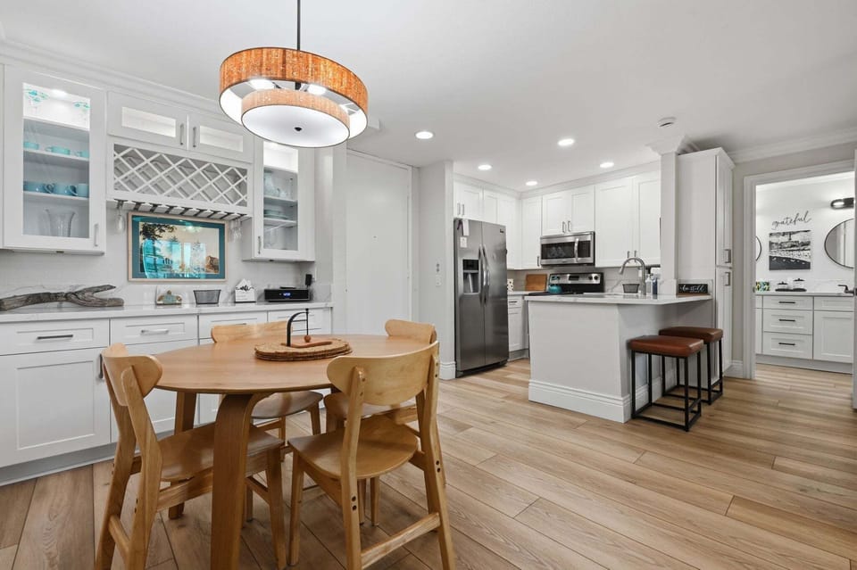 Experience the effortless flow of this bright, updated space where the kitchen, bar, and dining areas blend into one social sanctuary.