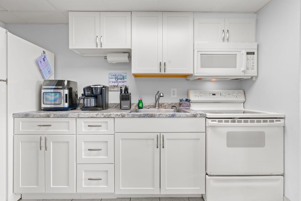 Full size fridge, range oven, microwave, coffee maker, dishes, utensils, basic pots and pans.