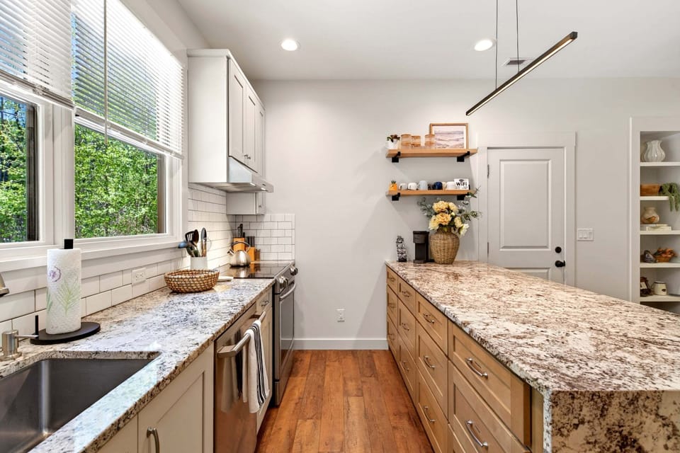 Main kitchen with island seating for 3, dishwasher, drip-style coffee maker, and Keurig coffee maker
