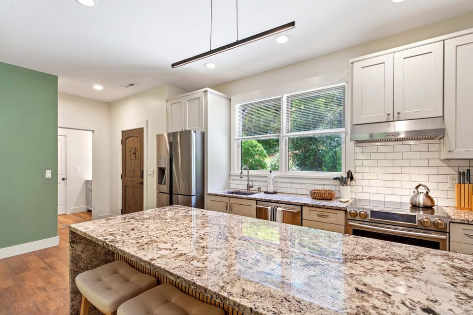 Main kitchen with island seating for 3, dishwasher, drip-style coffee maker, and Keurig coffee maker
