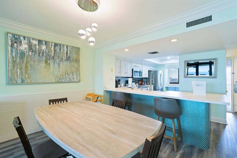 Experience effortless coastal living with an inviting dining area, spacious breakfast bar, and beautifully renovated kitchen in this direct beachfront Destin vacation rental.