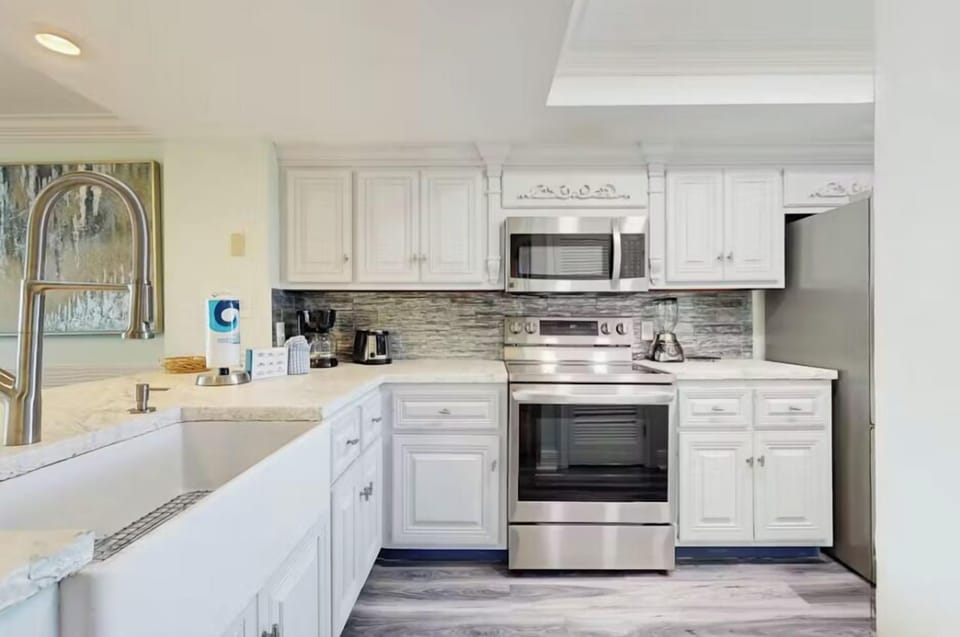 Look at this beautiful and updated kitchen! With a giant farmhouse sink and stainless steel appliances you can skip the restaurant crowds and prepare meals at home!