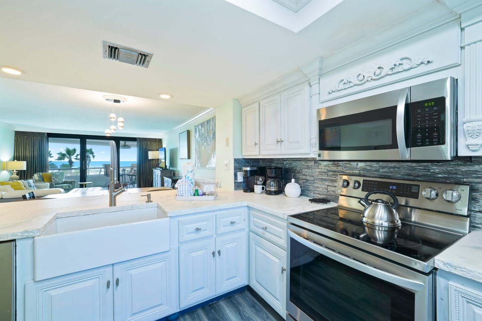 This bright Gulf front vacation rental offers a fully equipped kitchen with stainless steel appliances, custom cabinetry, and everything you need for family meals.