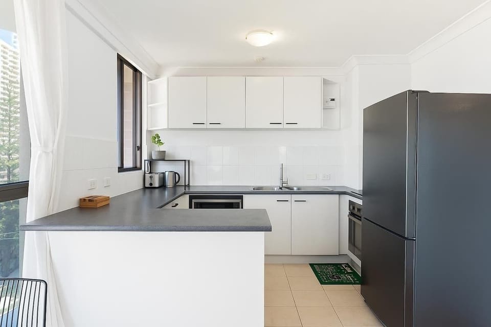Fully equipped modern kitchen with appliances and ample bench space