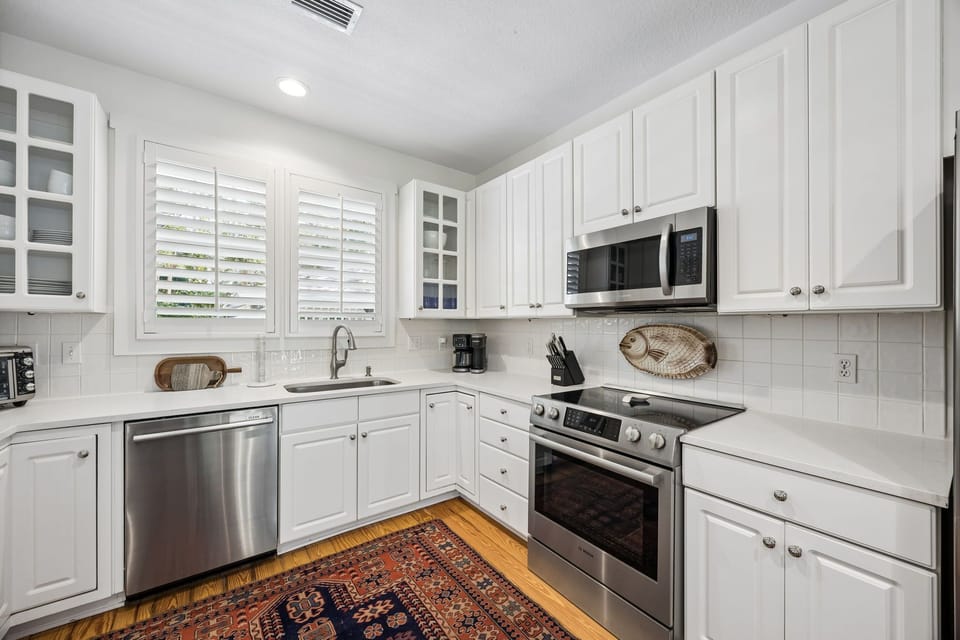 Updated Kitchen with Quartz Countertops, Stainless Steel Appliances, and Barstool Seating for 2
