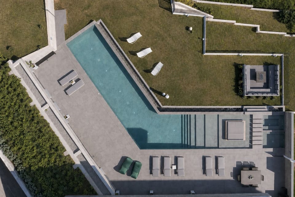 Bird’s-eye view of the immaculate pool, featuring swim-up sunbeds, a children’s 