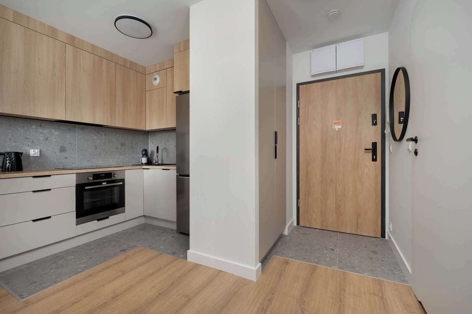The sleek design of the kitchenette blending seamlessly with the living area.