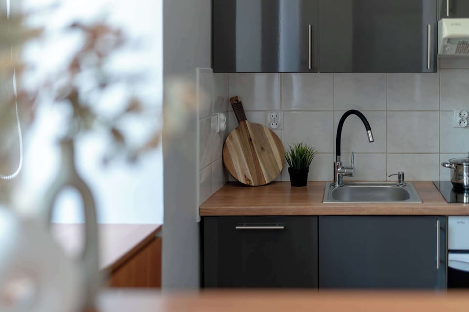 A close-up of a kitchen countertop with wooden accents. The design emphasizes simplicity and modern style.
