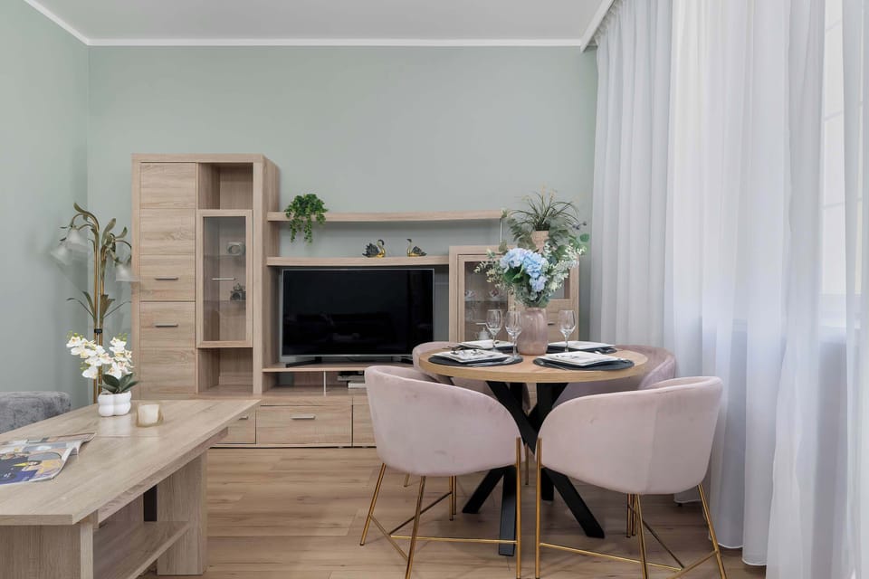 A dining area with a round table and chairs. It is a comfortable space for meals or gatherings.