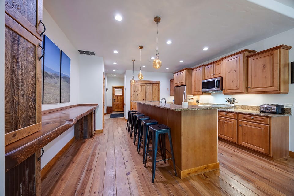 Your spacious mountain kitchen blends rustic warmth with modern convenience—gather around the island for coffee or create memorable meals together.