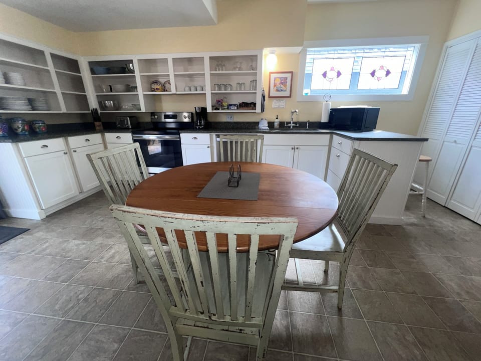 Step into your fully equipped galley kitchen with modern appliances and charming nautical details overhead.