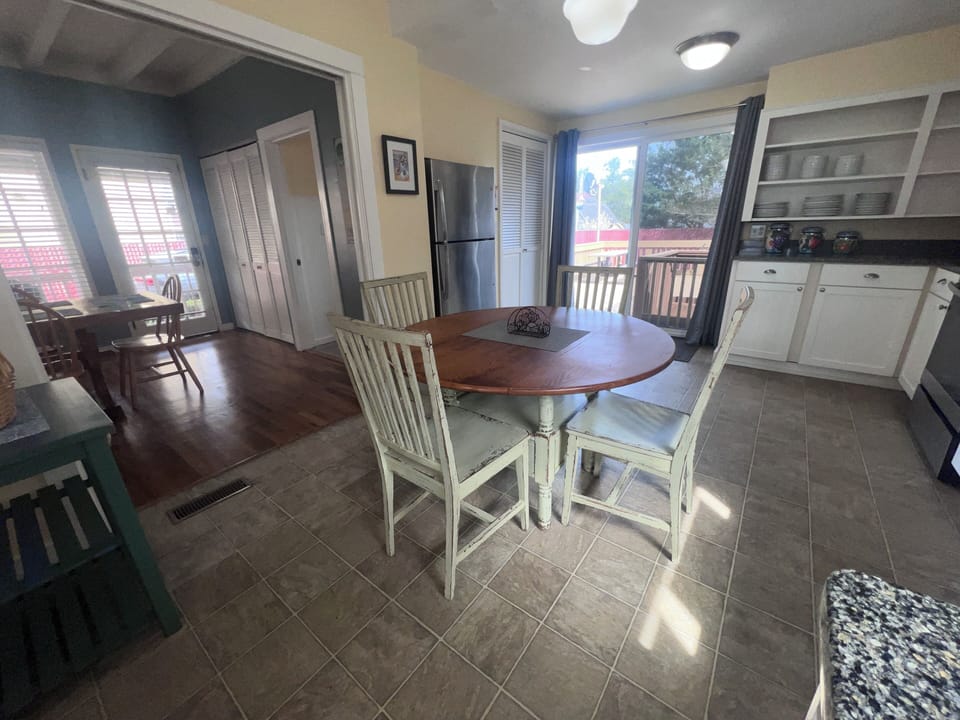 Step into your unique loft-style retreat with spiral stairs leading to a cozy elevated sleeping area, complete with modern kitchen amenities below.