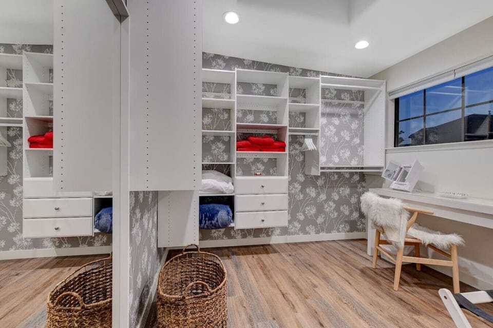 Unpack, settle in, and get ready in absolute style! This massive, custom walk-in closet doubles as a private dressing room, offering a level of convenience and luxury you rarely find while traveling.