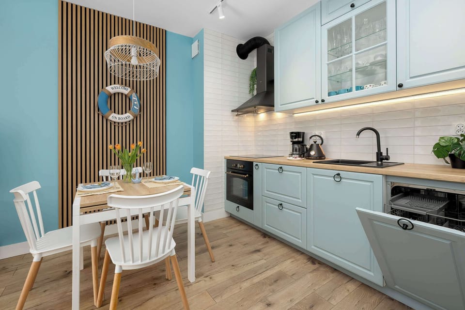 A stylish wooden slatted wall panel serves as a backdrop for the dining area. A nautical-themed lifebuoy decoration adds a playful maritime touch to the decor.