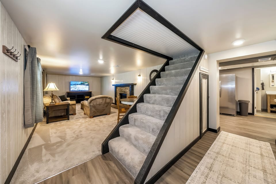Your private basement retreat features cozy seating, a warm fireplace, and entertainment space perfect for relaxing evenings together.