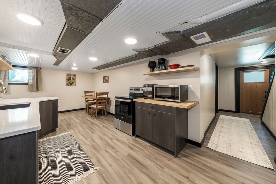 Your fully equipped kitchen features modern appliances and a cozy dining nook, perfect for preparing meals and enjoying intimate dinners together.