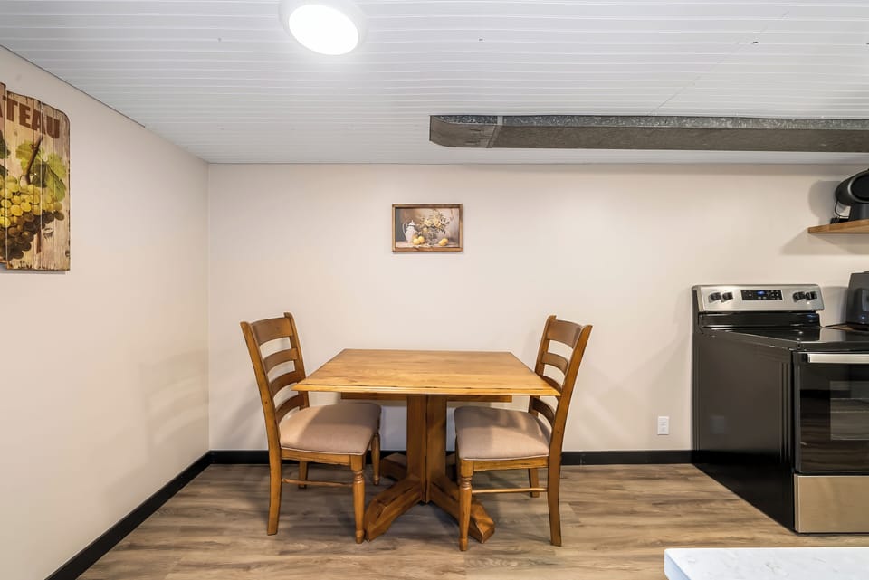 Gather around your cozy dining table for intimate meals in this warm, well-appointed space with rustic charm and modern conveniences.