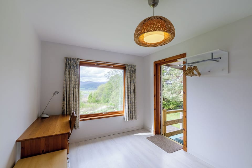 Spare room with desk, sofa and back door. Great for muddy feet and paws!
