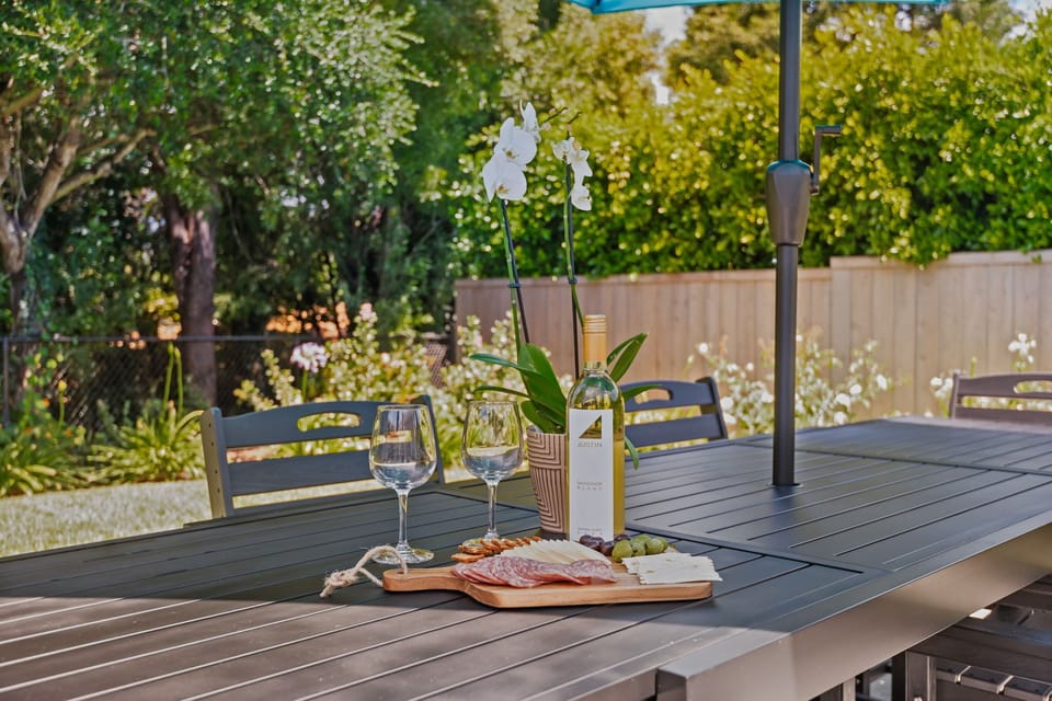 Savor wine and charcuterie on your private patio, where elegant white orchids and lush greenery create the perfect setting.