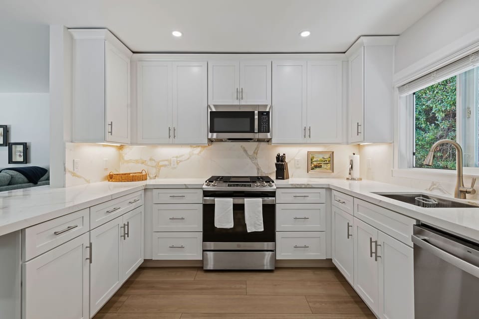Step into your chef's paradise with gleaming white cabinets, quartz countertops, and stainless steel appliances waiting for your culinary adventures.
