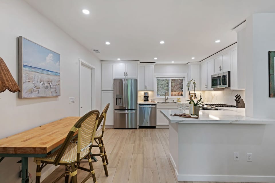 Your gourmet kitchen awaits with gleaming white quartz counters, stainless steel appliances, and coastal charm throughout.