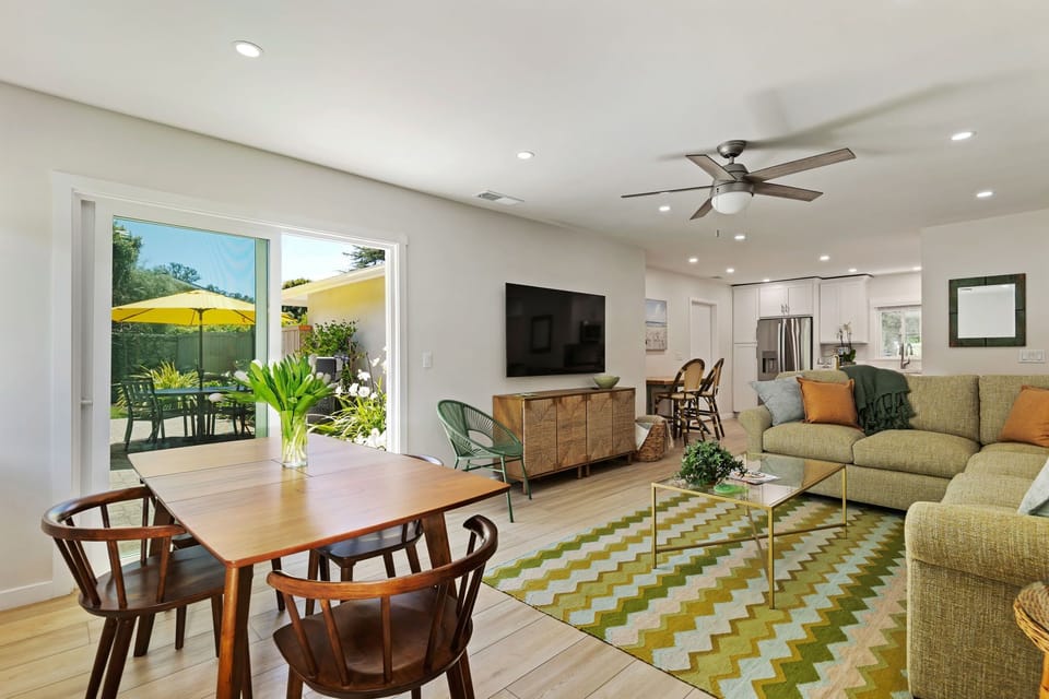 Relax in your bright, modern living space where comfort meets style, complete with dining area and peaceful patio views.