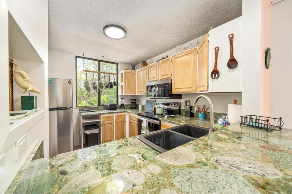 Cook memorable meals in this bright kitchen with granite counters, modern appliances, and forest views from your window.