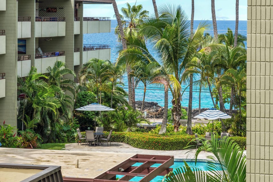 Tropical paradise awaits beyond your balcony, where swaying palms frame turquoise waters and lush gardens create your private oceanfront escape.