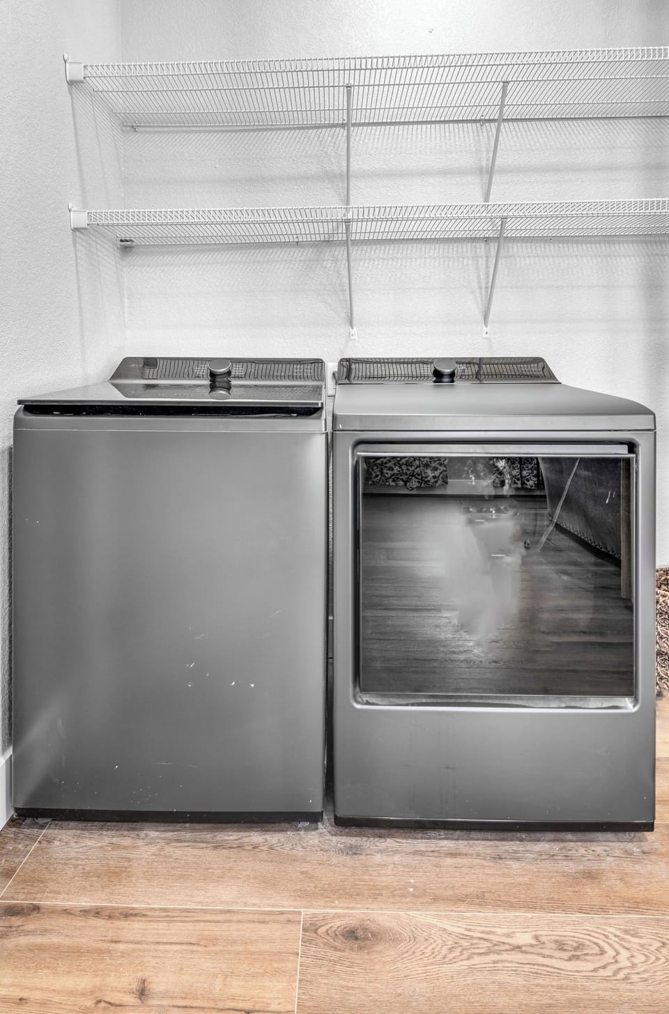 Keep your clothes fresh with these full-size washer and dryer units, complete with convenient wire shelving for organizing your laundry essentials.