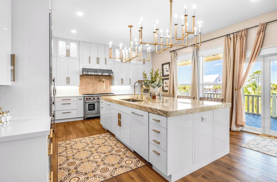 Your gourmet kitchen awaits with marble countertops, premium appliances, and elegant chandeliers creating the perfect space for memorable meals.