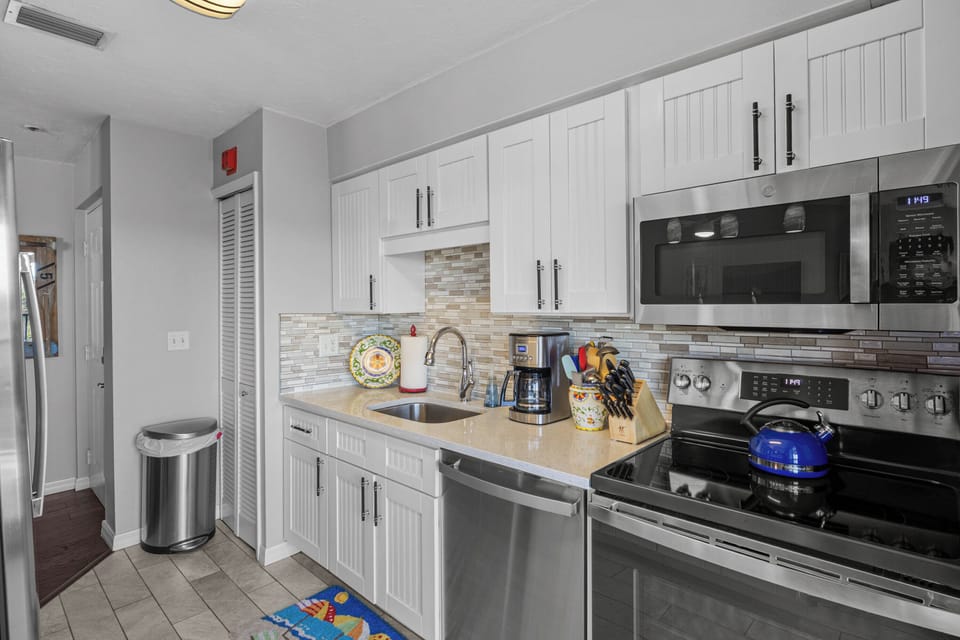 Your fully equipped kitchen features white cabinetry, stainless steel appliances, and everything you need to create memorable meals during your stay.