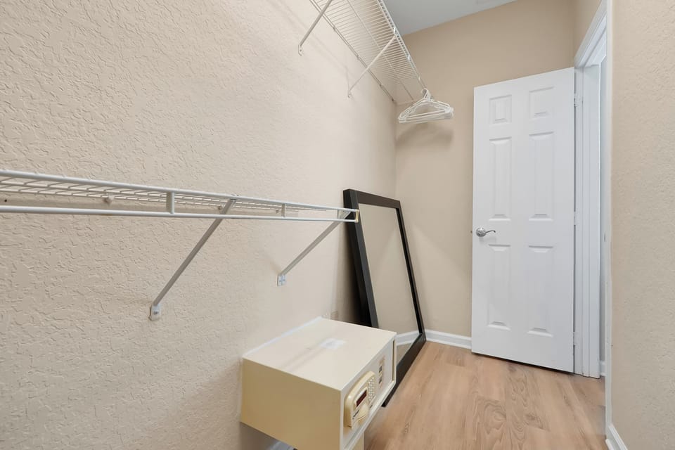 Your spacious walk-in closet offers ample hanging space and storage for all your belongings during your stay.