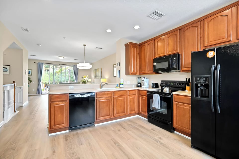 Your spacious kitchen features warm wood cabinets, granite countertops, and modern appliances—perfect for preparing home-cooked meals.
