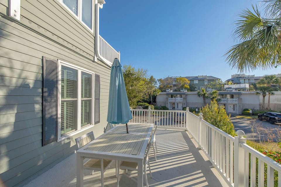 Step onto your private deck where morning coffee and afternoon relaxation await, with coastal neighborhood views stretching beyond.